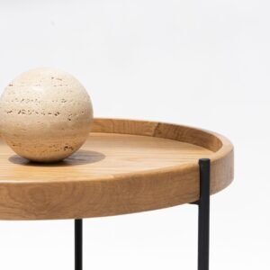 A minimalist wooden table featuring a spherical ornament, perfect for interior design inspiration.