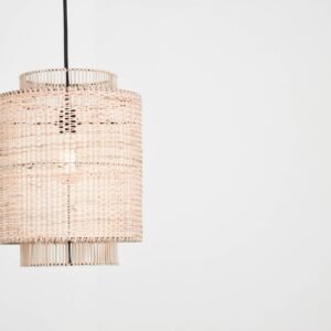 Elegant rattan pendant lamp with woven design against a stark white backdrop, perfect for interior decor inspiration.
